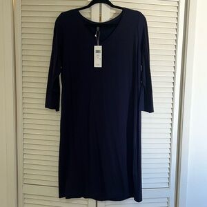 Dress is a relaxed, dark navy blue garment with a scoop neckline.